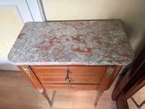 a marble top table with a drawer underneath it