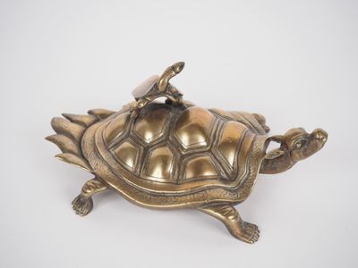 brass figurine of a turtle with a umbrella on its back