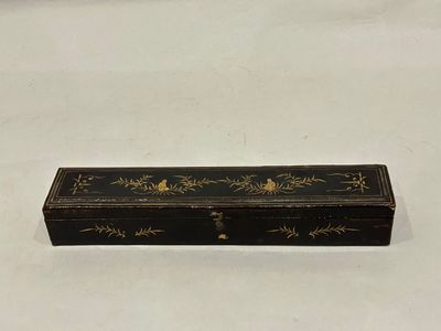 a black and gold box sitting on top of a white table