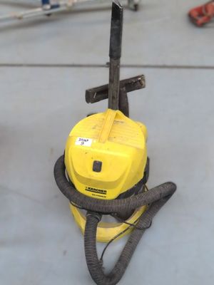 a yellow vacuum cleaner sitting on the floor in a room