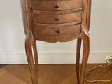 a small wooden table with a drawer on top of it