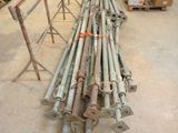 a pile of metal pipes and poles in a warehouse
