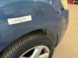 a blue car with a sticker on the side of it