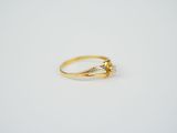 a gold ring with a single diamond on the side