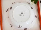 a plate with a picture of birds on it in a box