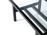 a glass table with black legs and a glass top