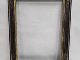 a black and gold picture frame on a white background