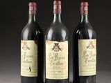 three bottles of wine are lined up on a table