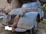 an old car that is sitting in the dirt
