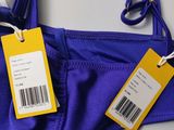 an image of a close up of a purple bikini with a price tag on it