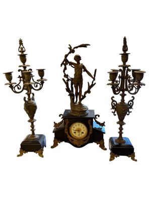 three different types of clocks on display on a white background