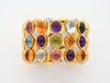 a close up of a gold ring with multi colored stones