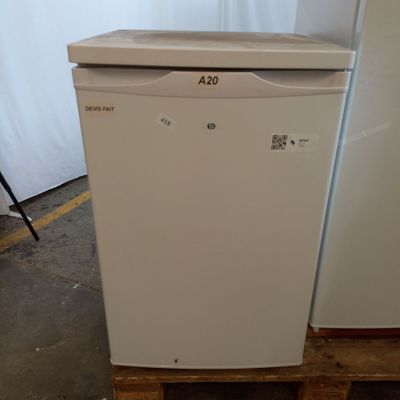 a white refrigerator sitting on a pallet in a warehouse