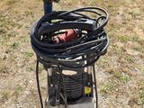 a machine that is sitting on the ground in the grass