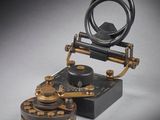 an old fashioned telephone is sitting on top of a table