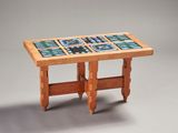 a wooden table with a tile top on it