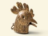 a gold statue of a rooster on a white background
