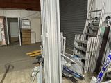 many ladders that are sitting in a warehouse