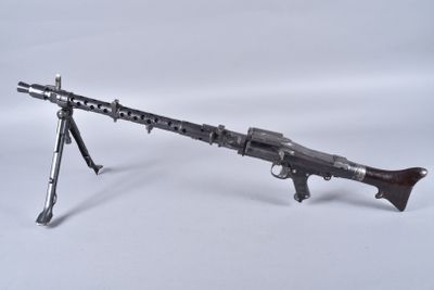 a toy gun with a wooden barrel on a white background