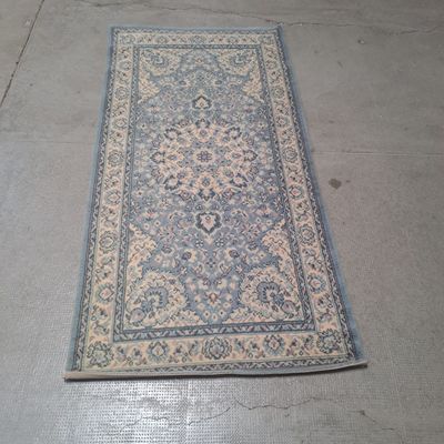 un tapis posé au sol au milieu de la pièce