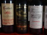 several bottles of wine are lined up in a row on a table