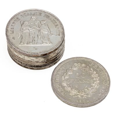 several coins are stacked on top of each other on a white surface