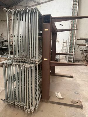 a large stack of metal pipes in a warehouse