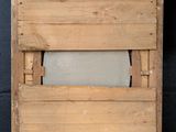 an old wooden box with a roll of toilet paper in it