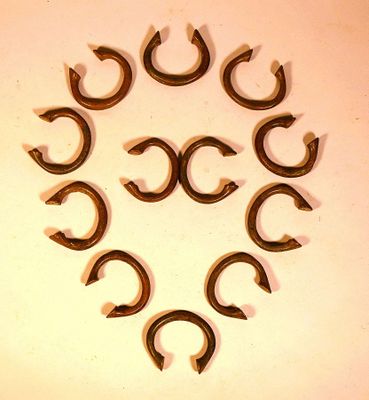 eight horseshoes arranged in a circle on a white surface