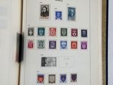 an open book with stamps on it on a table