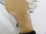 heel of a woman ' s shoe sitting on top of a white table