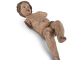 an old wooden doll laying on its side on a white surface