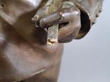 a statue of a man holding a cigar in his hand