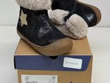 pair of baby shoes in a box on a white surface