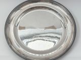 a silver plate with a mirror in the middle of it