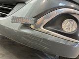a close up of a car ' s headlight with a measuring tape on it