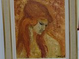 painting of a woman with long red hair in a gold frame