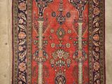 an old rug hanging on a wall in a room