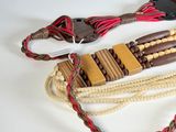 a brown and red belt with a rope on it