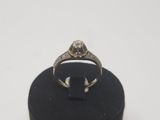 a close up of a diamond ring on a black ring stand