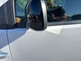 a reflection of a man in the side view mirror of a car