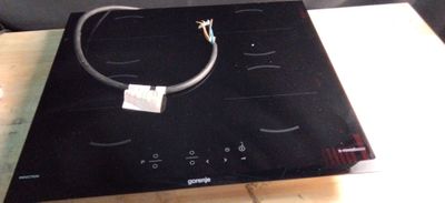 a black stove top with a wire on top of it