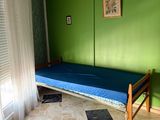 an image of a bedroom with a bed and a rug