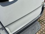 a close up of a door handle on a white truck