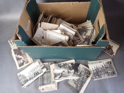 a box full of old photos of people and buildings
