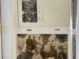 an old photo of a group of men sitting on top of a book