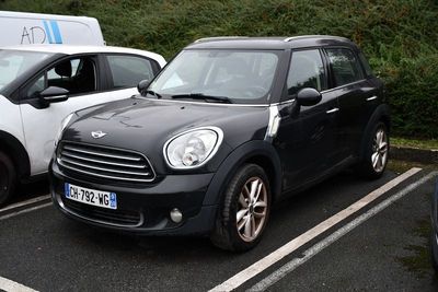two cars parked in a parking lot next to each other