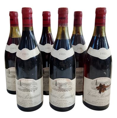 six bouteilles de vin sont alignées sur une surface blanche