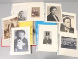 a lot of old black and white photos on a table