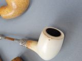 a pipe and a pipe holder sitting on a table